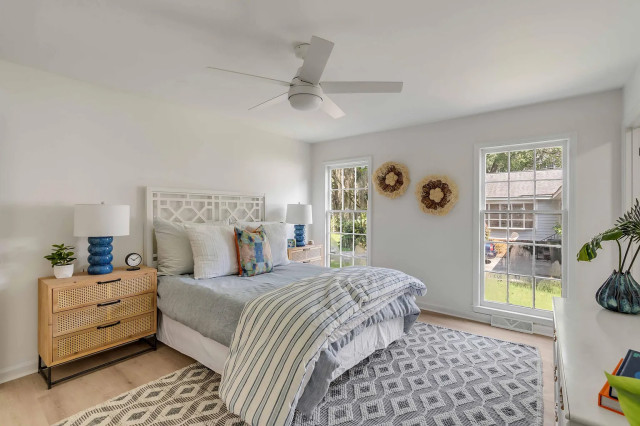 Guest bedroom with rattan nightstand and woven wall art