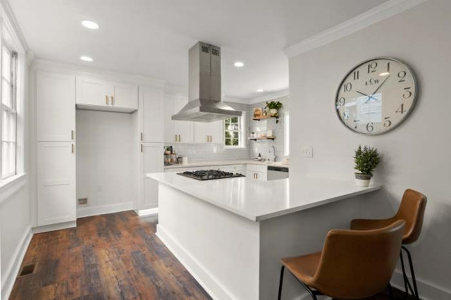 Kitchen with white cabinetry and quartz island