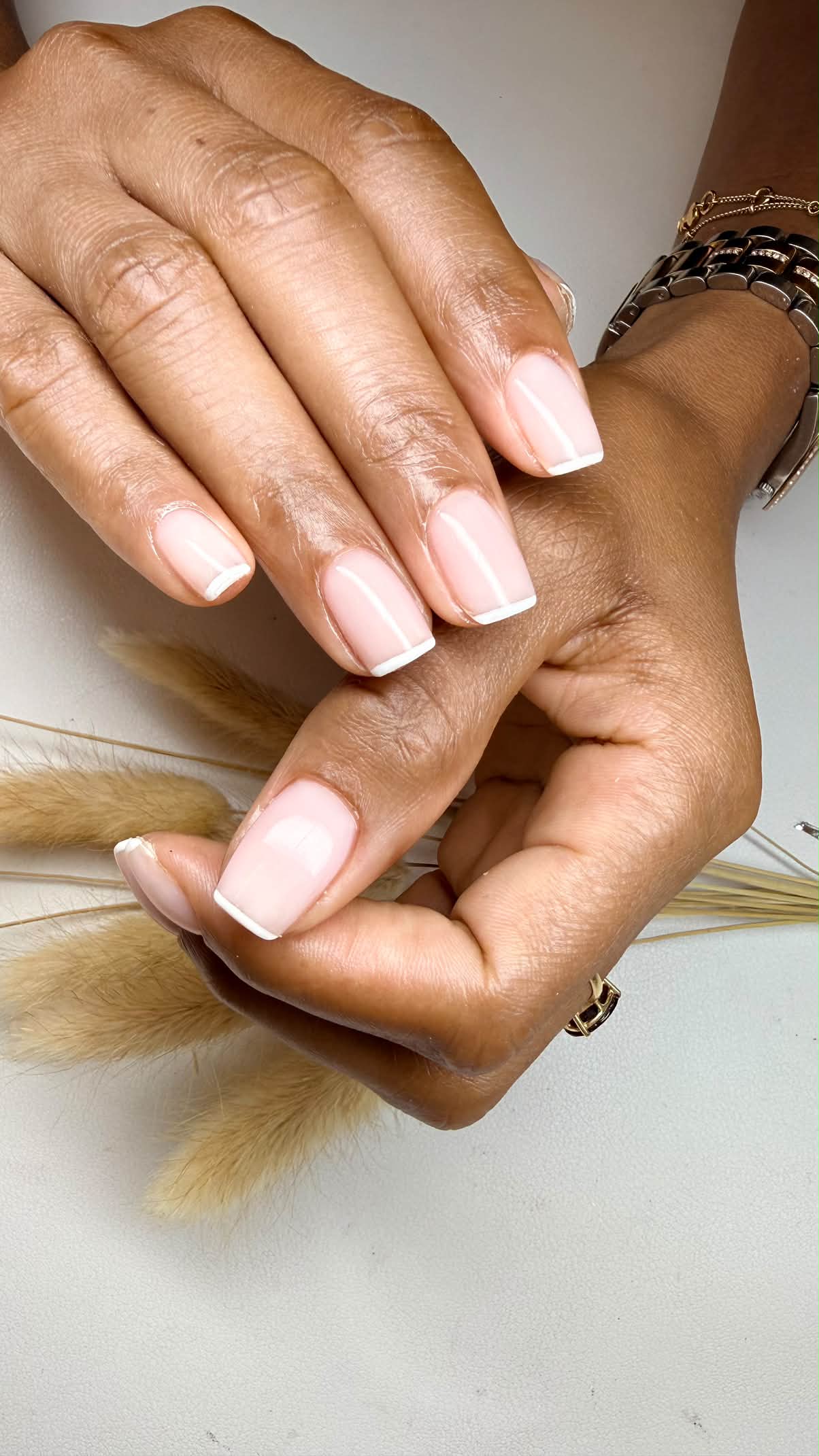 Classic short square pink nails with crisp white French tips