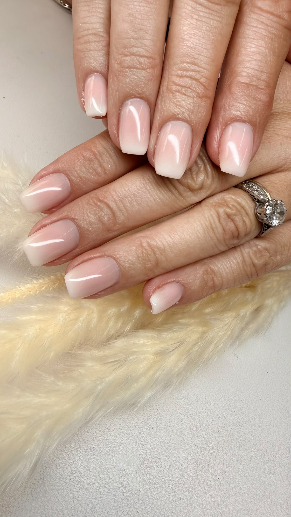 Square-shaped nails with a pink-to-white ombre finish