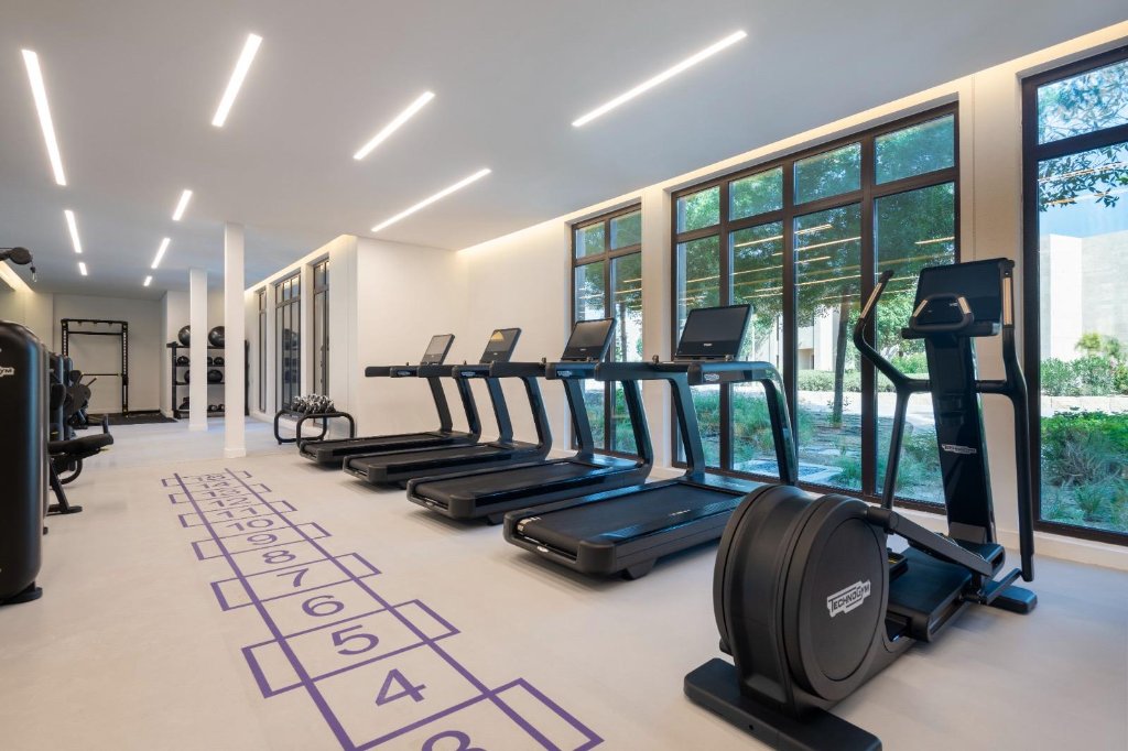 Residential tower amenity gym Qatar - Technogym cardio suite luxury apartment building Lusail Doha