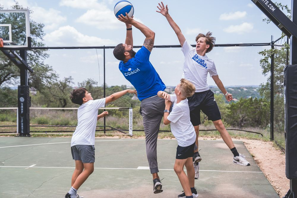 Young athletes practicing basketball outdoors