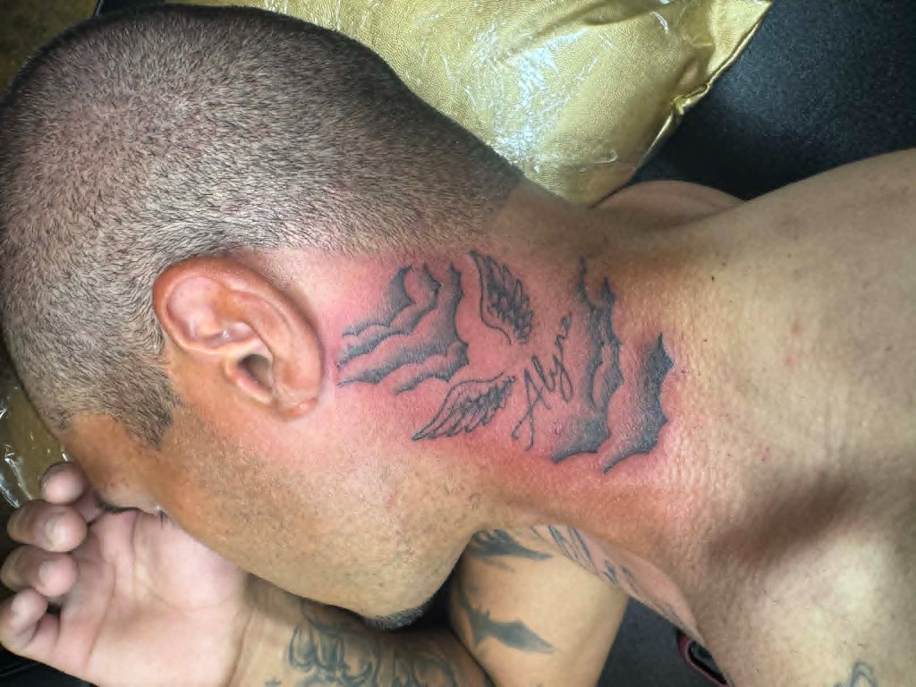 Wings neck tattoo
