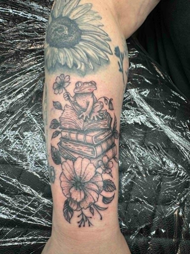Frog with books and flowers tattoo