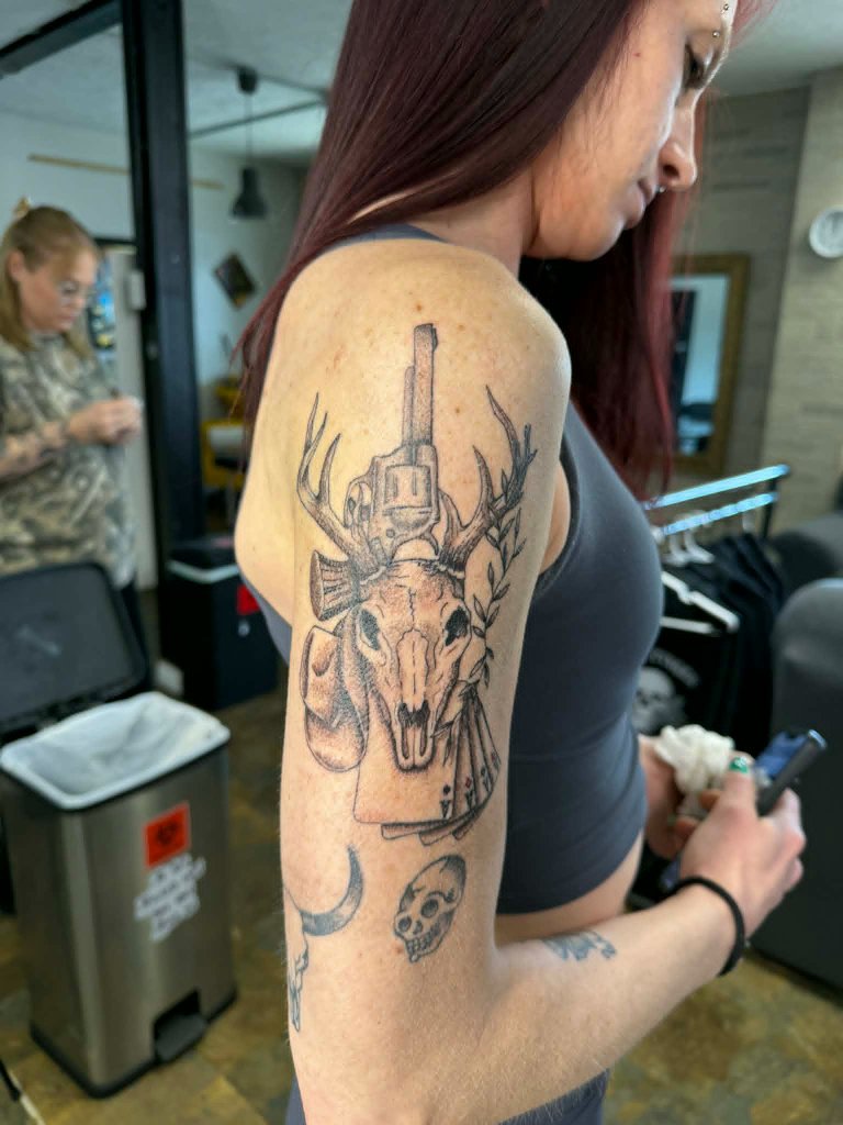 Deer skull with gun and playing cards