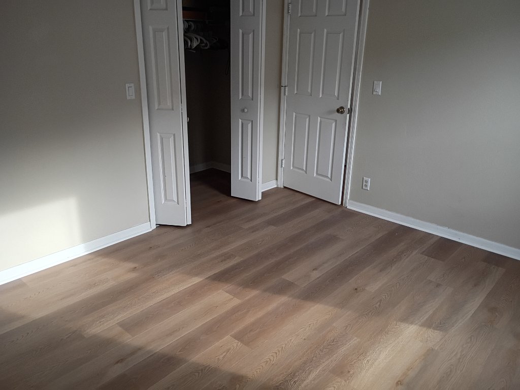 Treasure Coast luxury vinyl flooring installation with warm oak tones in finished residential living space