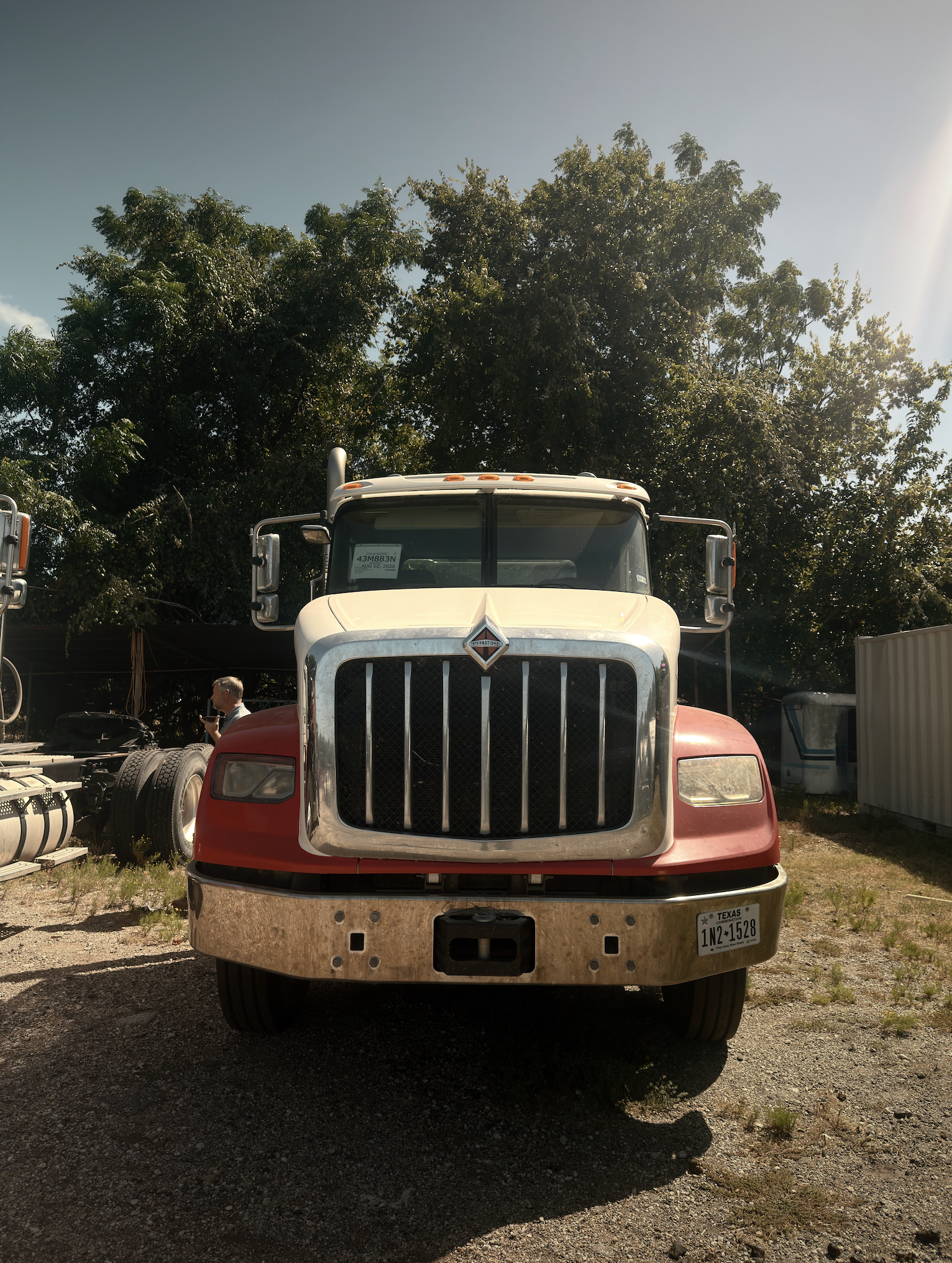 International semi-truck parked on gravel lot in Texas awaiting commercial repair