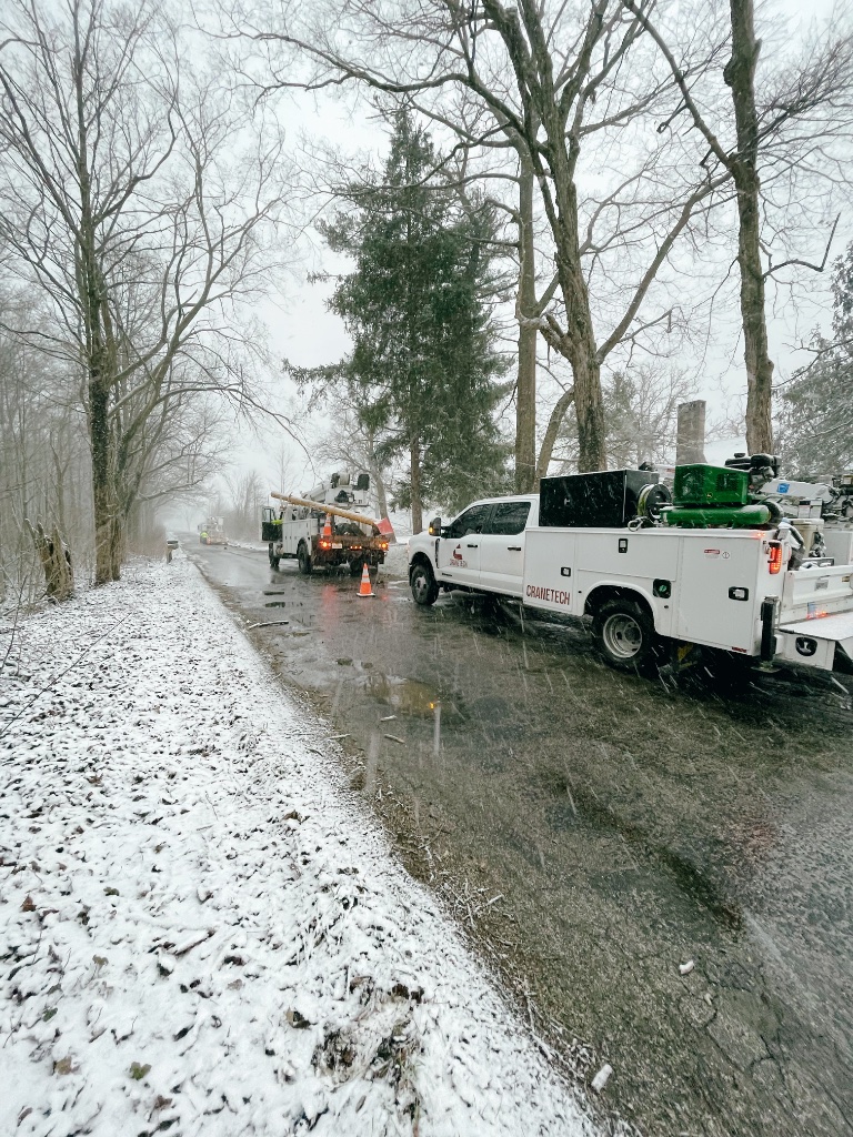CRANETEC mobile oil change fleet service — service truck and utility equipment deployed at job site in winter conditions
