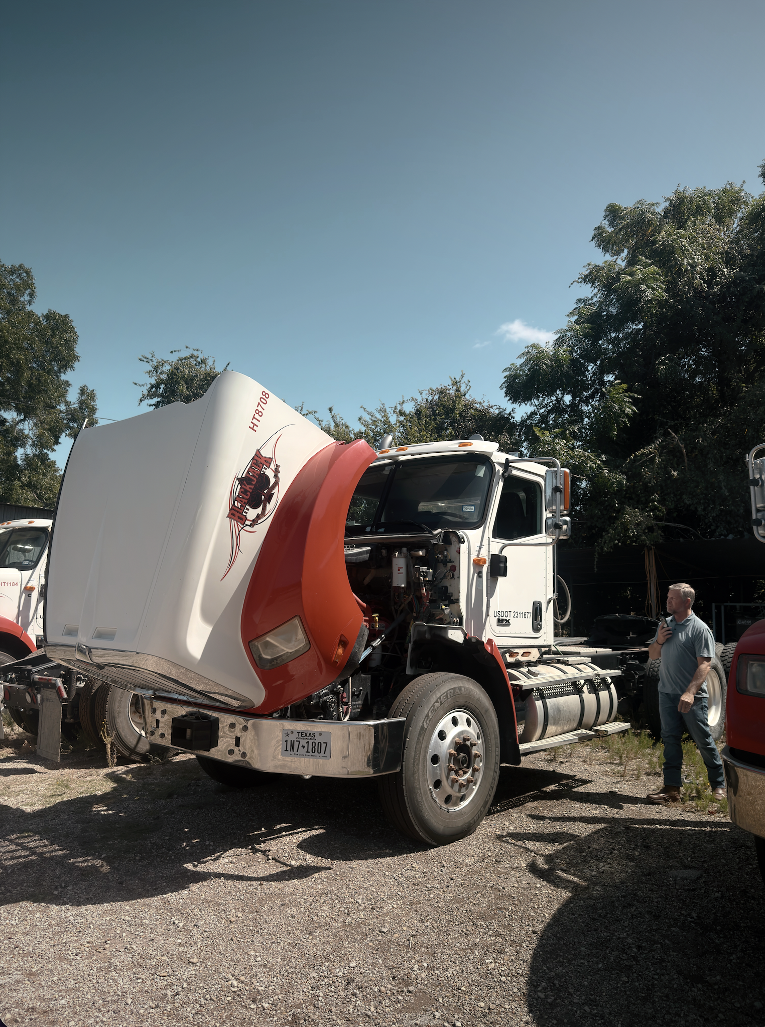 International semi-truck with hood open for engine service in Hubbard, TX