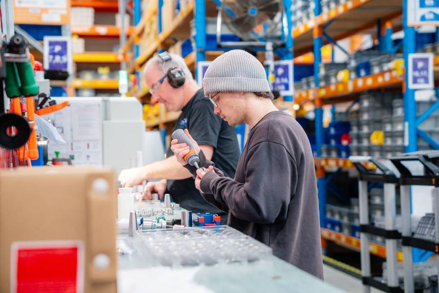 Mentor and learner working together at a manufacturing workbench