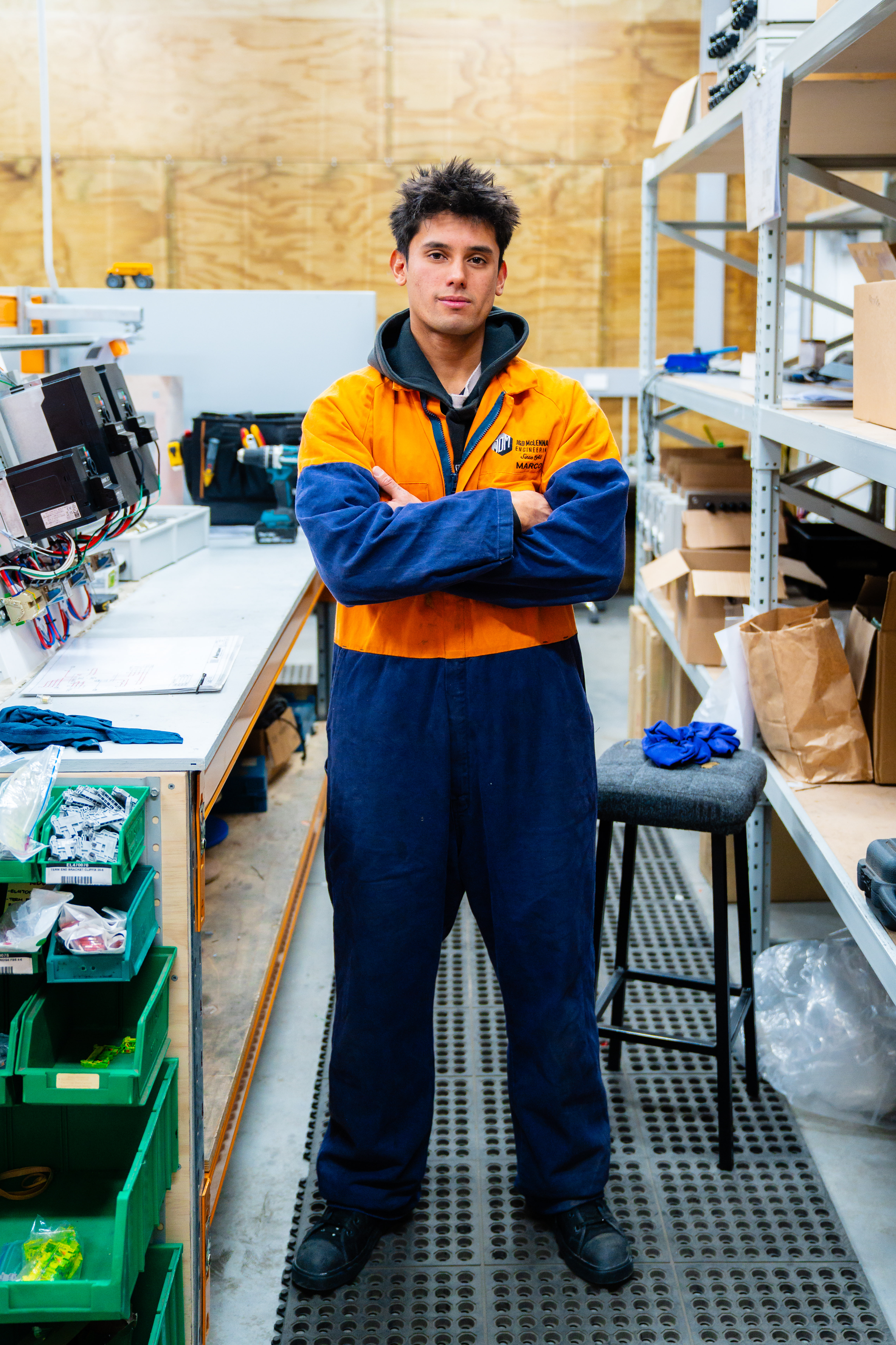 Young learner in a manufacturing workshop wearing high-vis overalls