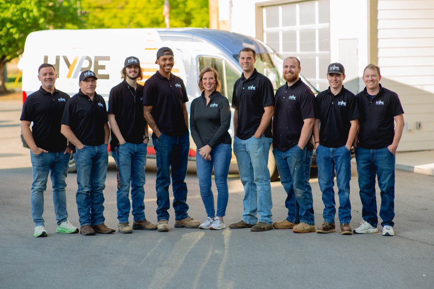 The HYPE Heating & Air team standing together beside a HYPE van