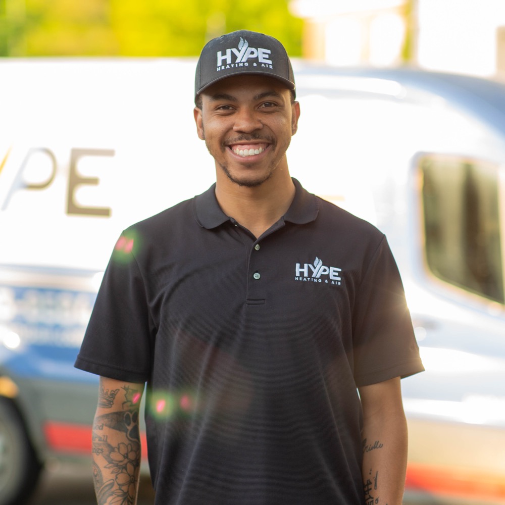 A HYPE team member in front of a branded service van