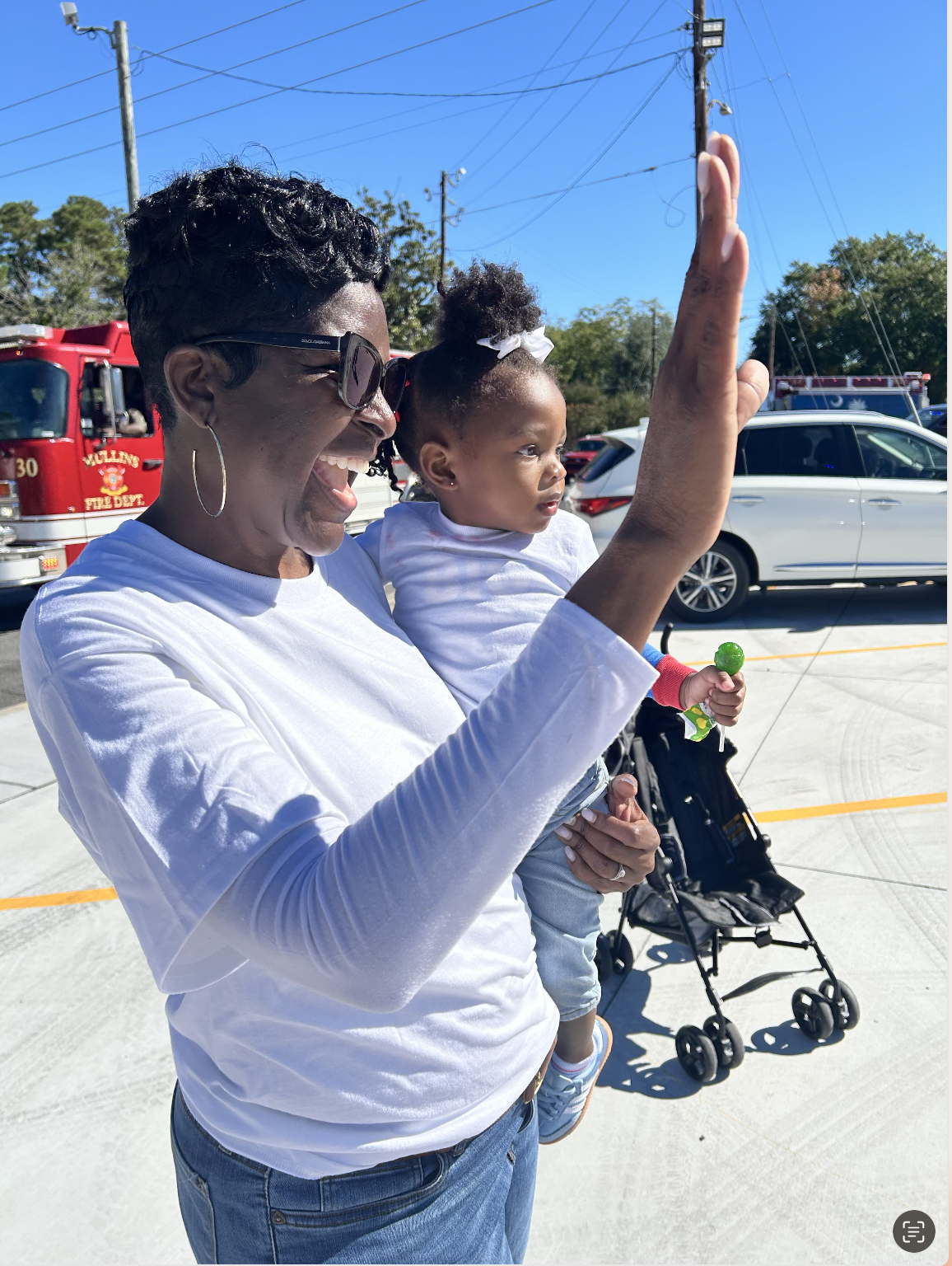 Waving to the crowd with a young supporter in tow