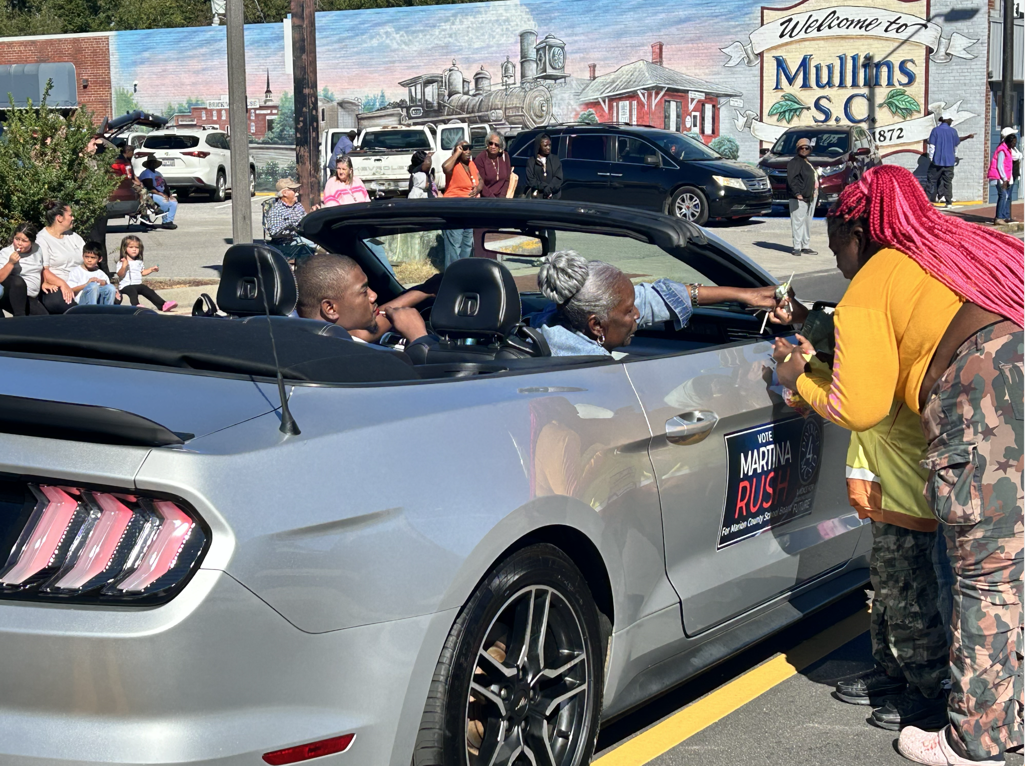 Meeting parade attendees along the route in Mullins