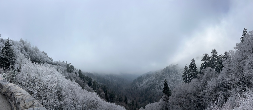 A frost-covered valley under low clouds — the emotional transition of the About page