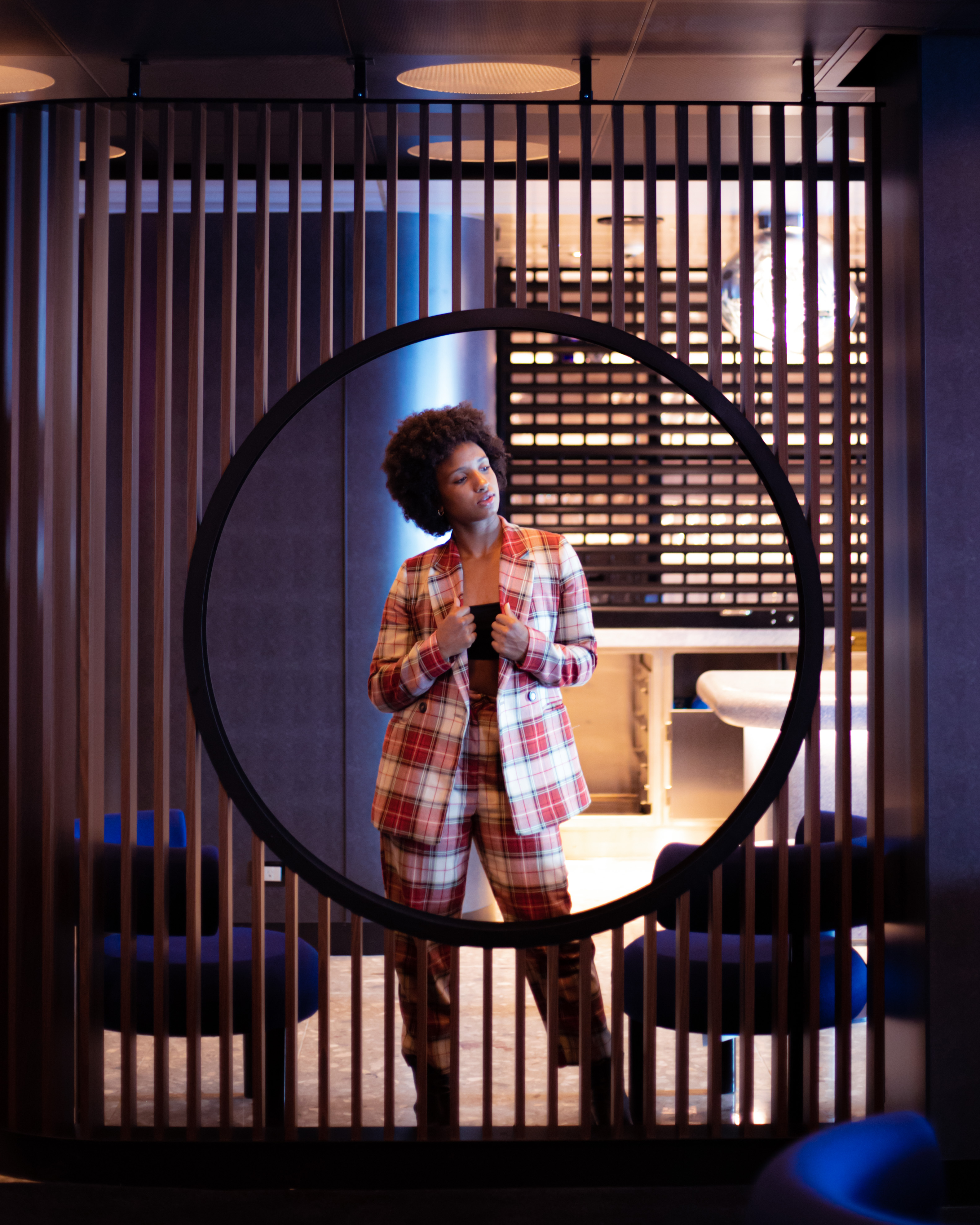 Executive aboard a Virgin Voyages ship, framed in a circular architectural element