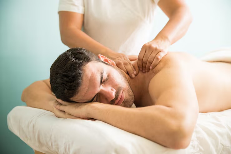 Man relaxing on a massage table receiving a professional M4M outcall massage