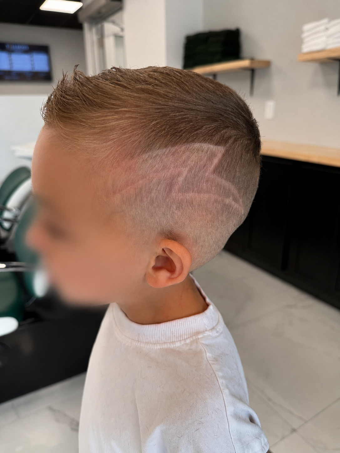 Kids fade haircut with shaved design at Tallboys Barbershop in Mount Pearl, NL
