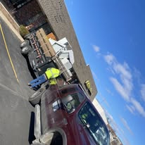 Junk removal crew hauling away debris