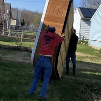 Crew removing large items from property