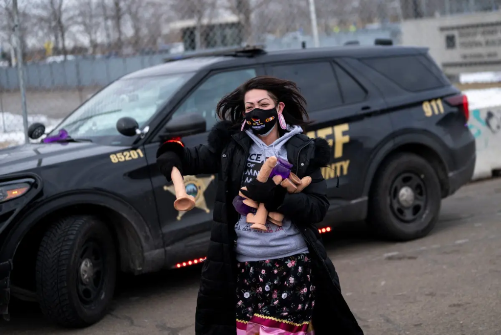 Anti-ICE protester outside Hennepin County Sheriff vehicle at Minneapolis rally