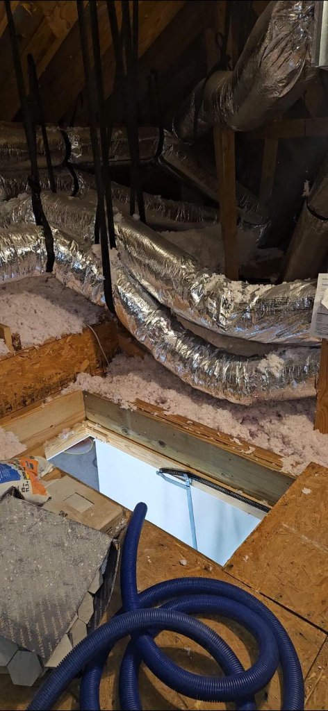 Attic insulation and ductwork inside a residential attic
