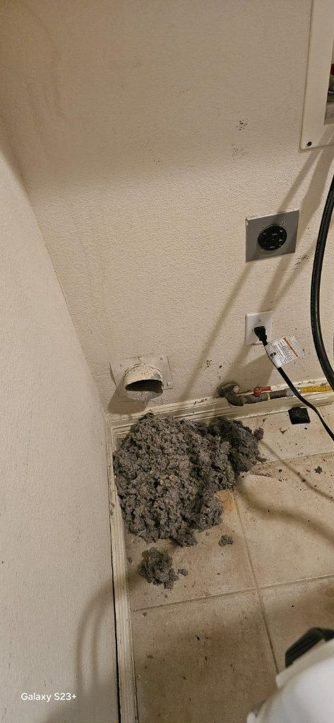 Lint removed from dryer vent on laundry room floor
