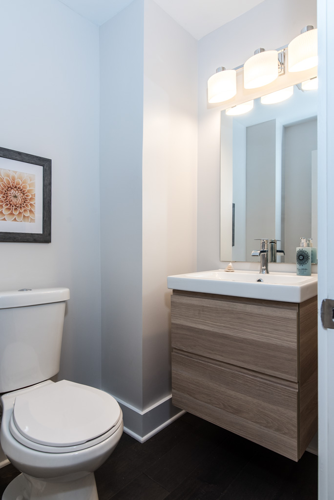 Half-bathroom with floating vanity and modern fixtures