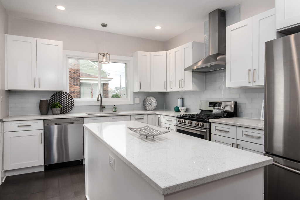 Modern white kitchen with island and stainless steel appliances