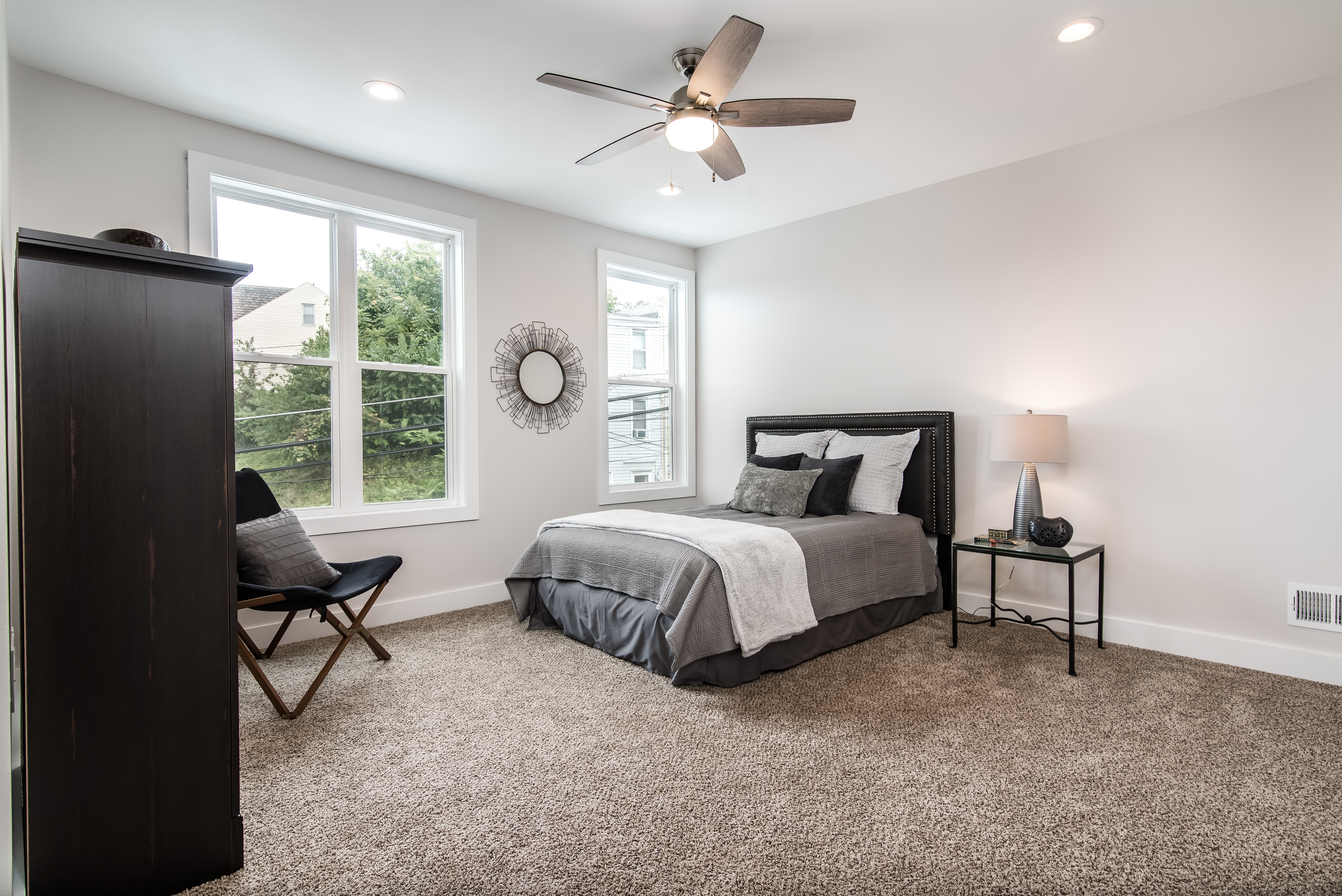 Furnished bedroom with upholstered headboard and neutral tones