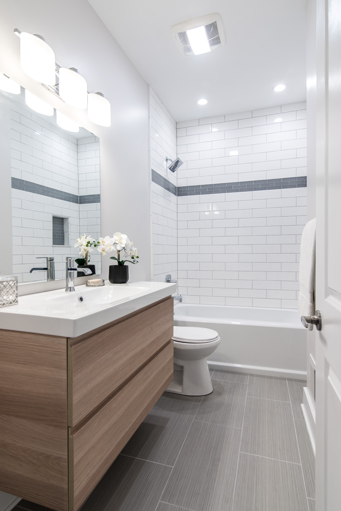 Renovated bathroom with floating vanity and subway tiles
