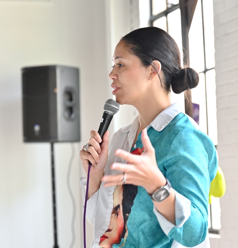 Lacey speaking with microphone