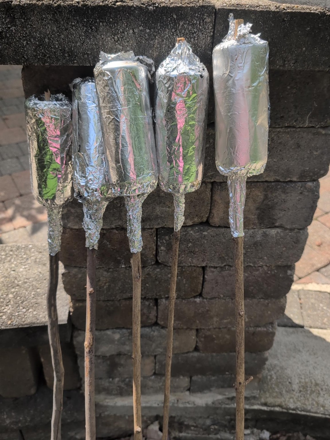 Foil-wrapped wooden sticks used as original chimney cake baking forms