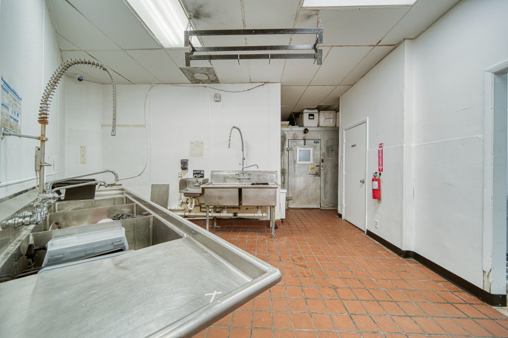 Three-compartment sink and walk-in cooler area