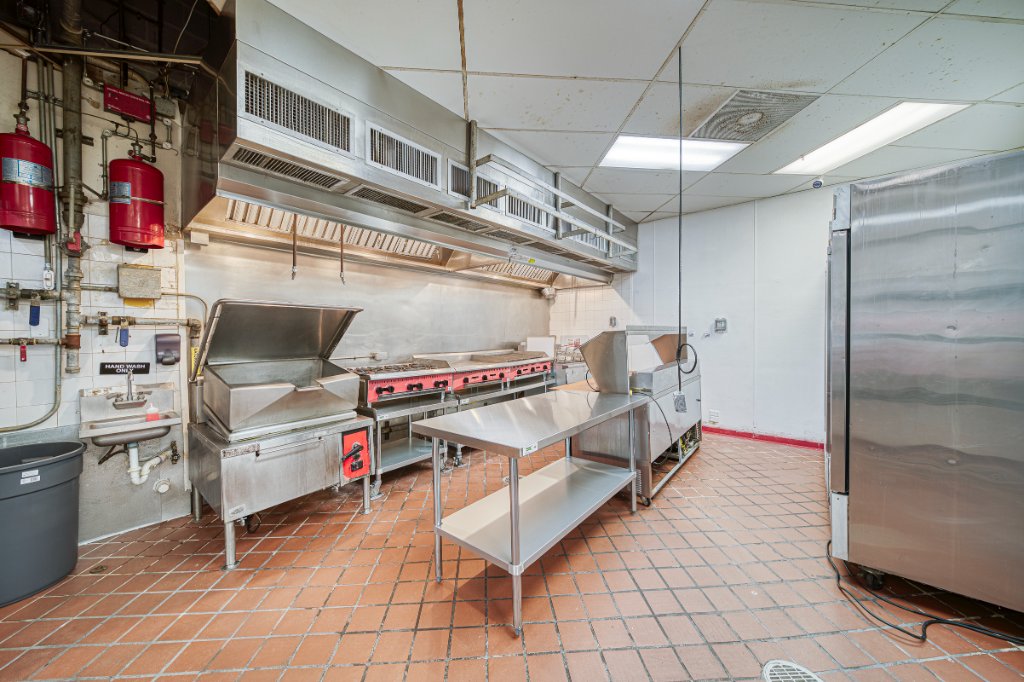 Commercial kitchen with deep fryer, griddle, and range