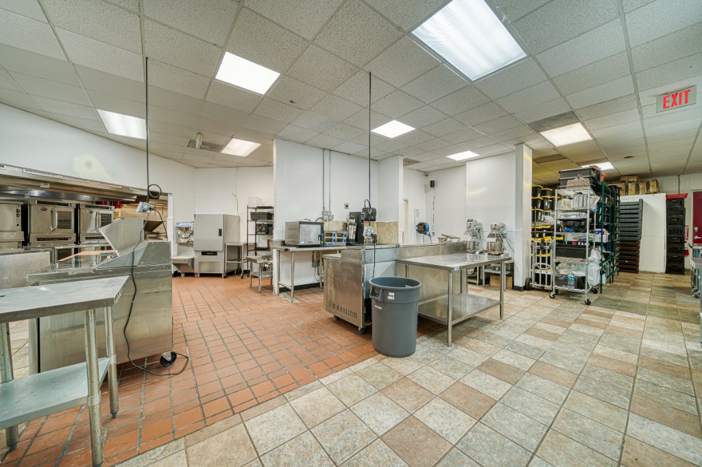 Commercial kitchen with stainless steel prep stations and ovens