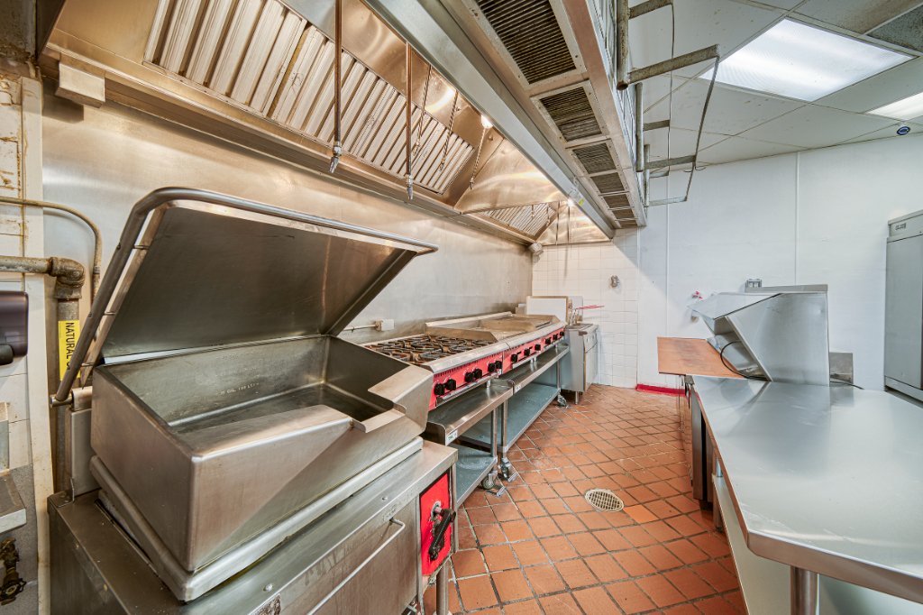 Cooking line with tilting skillet, range, and exhaust hood