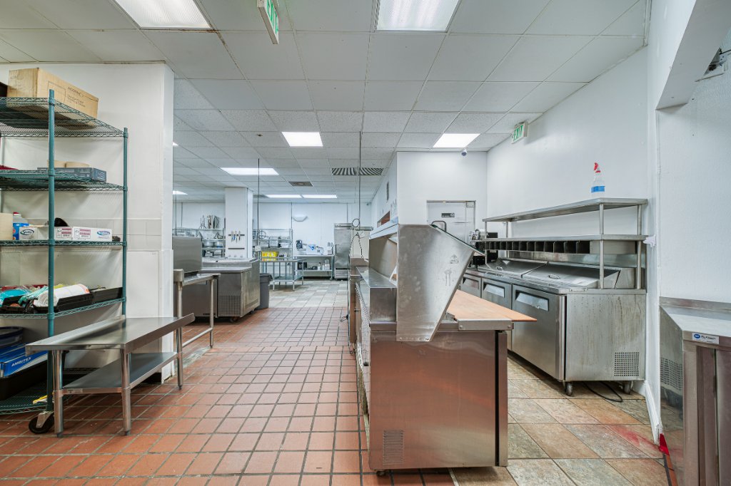 Kitchen prep area with shelving and refrigerated station