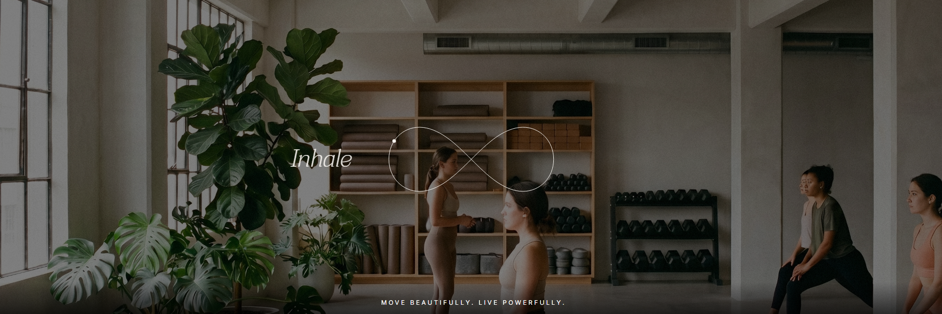AURA fitness studio website design concept showing a yoga studio interior with an infinity symbol, Inhale text, and Move Beautifully. Live Powerfully. tagline.