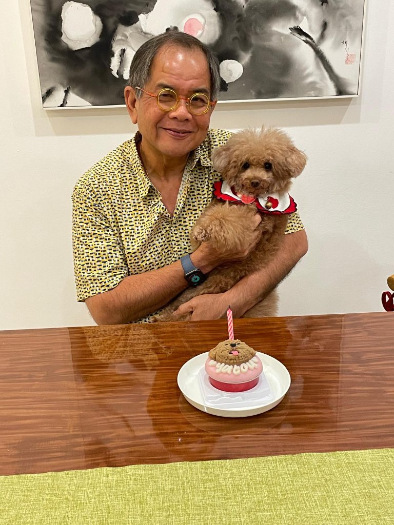 Richard with his beloved dog Yatou, celebrating together