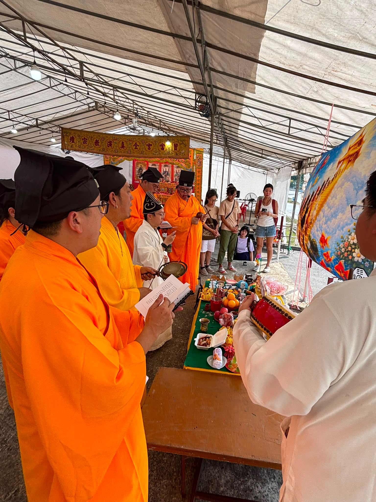Taoist ritual practitioners recite scriptures and conduct salvation rites over three days.