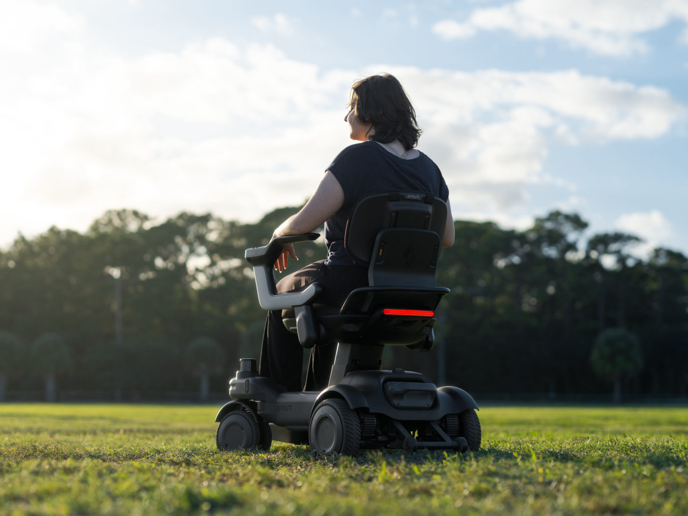 Strutt ev¹ adjustable seat, backrest and folding armrest shown in a seating position