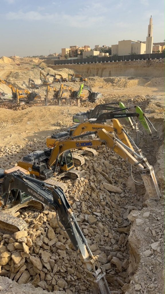 Excavation fleet operating on rocky terrain during daytime