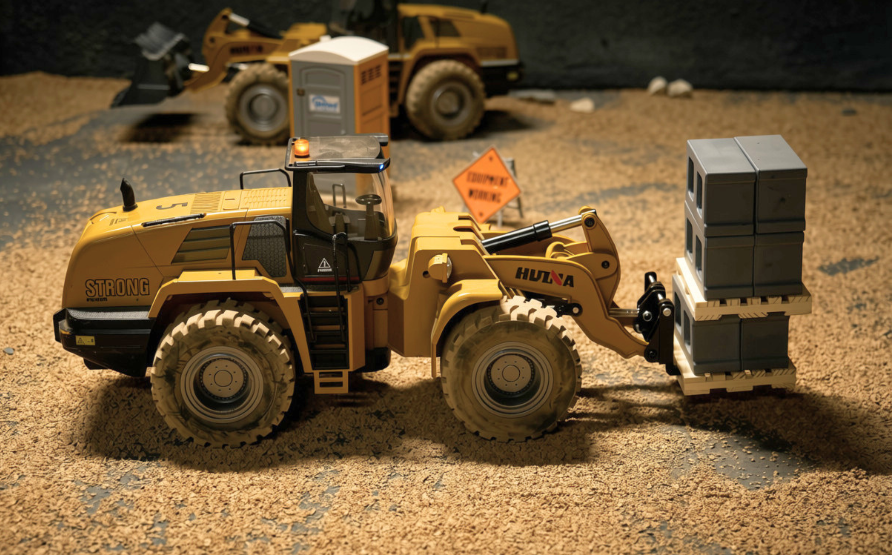 RC wheel loader hauling blocks on the DirtLab construction site