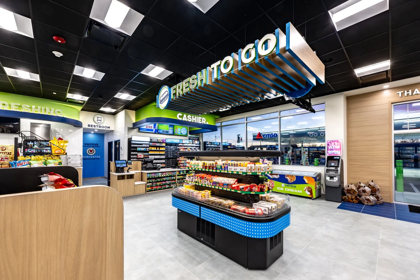 Modern convenience store interior with stocked shelves and signage