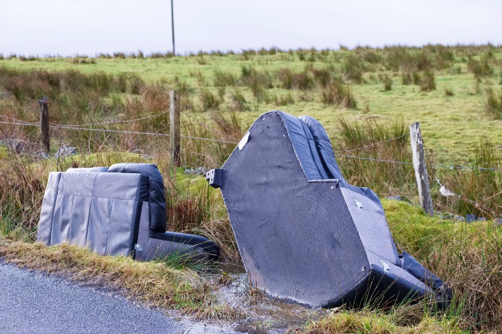 Fly-tipped furniture dumped at a roadside