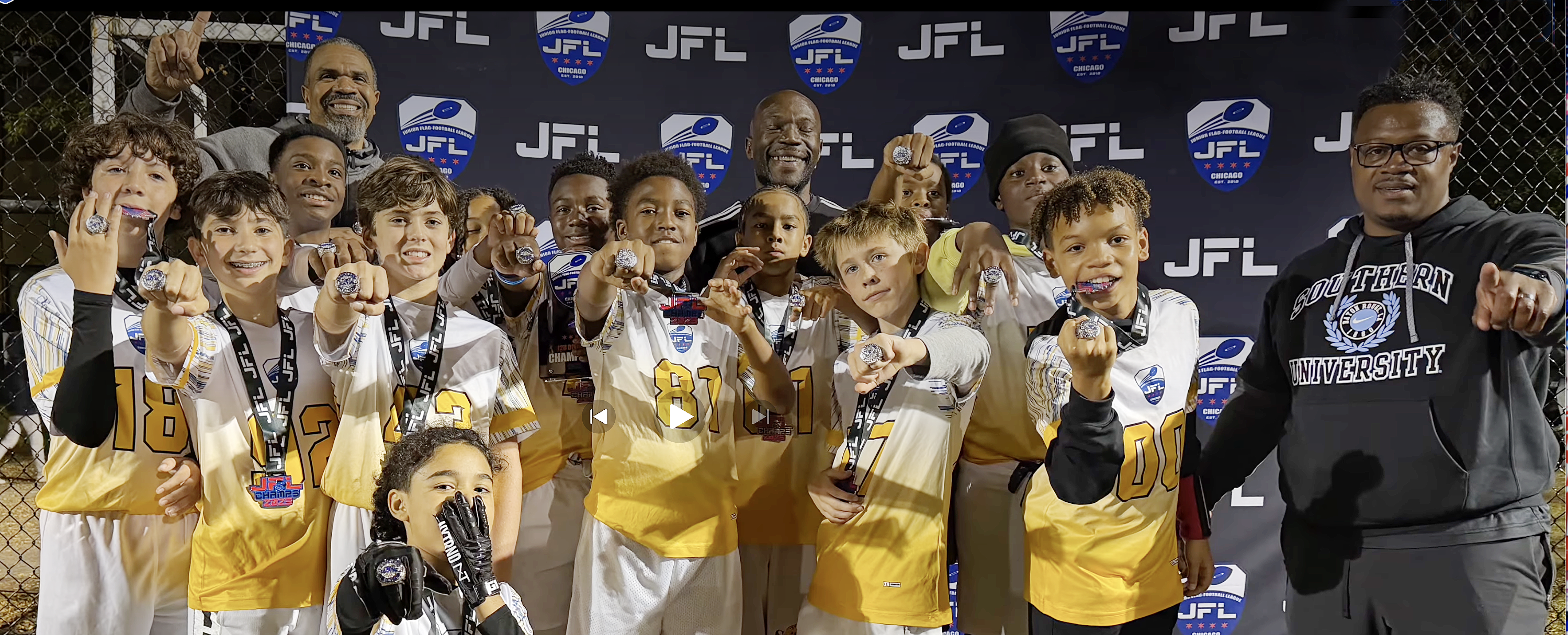 JFL championship team in gold jerseys holding up their championship rings
