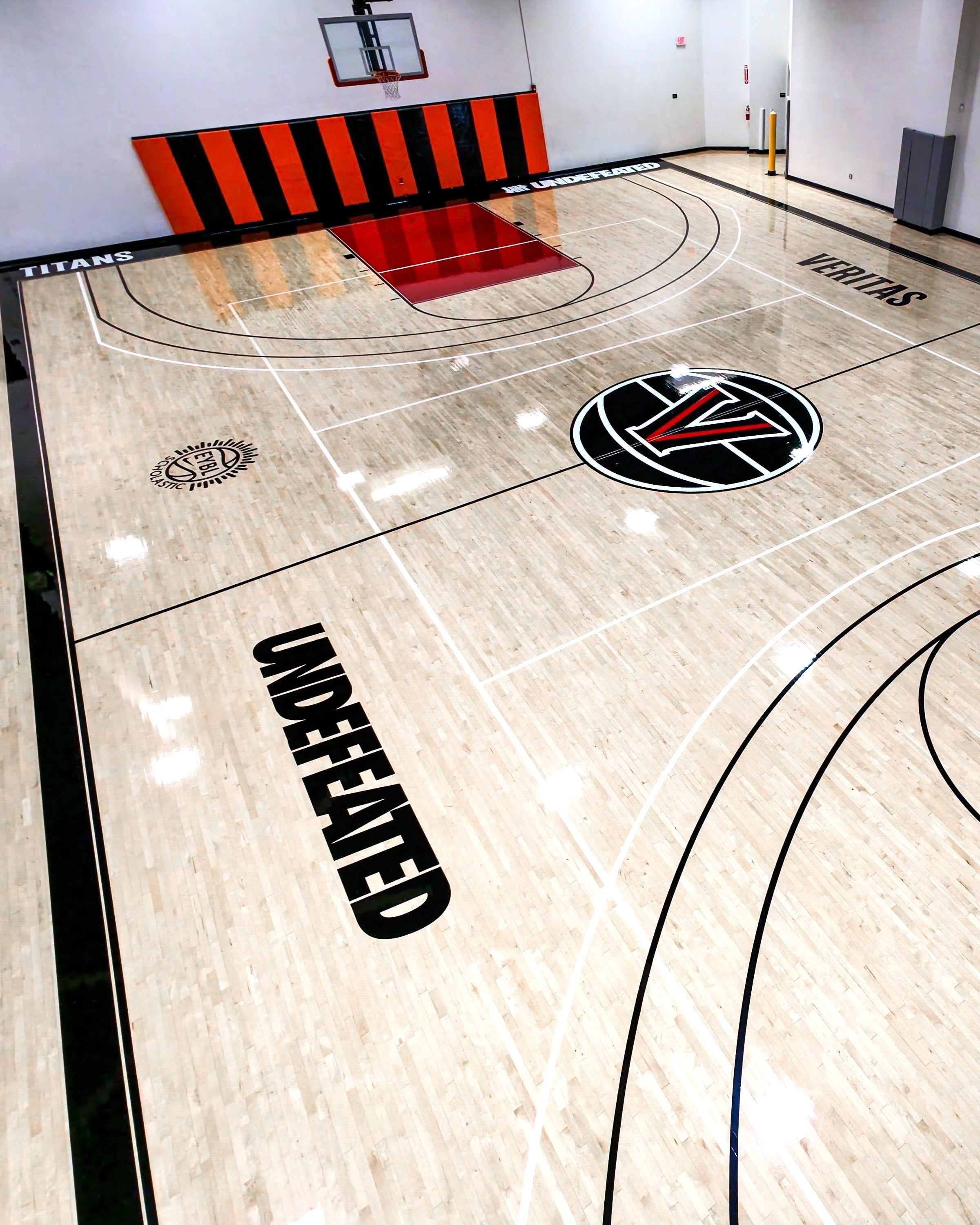 Velocity HQ indoor hardwood court with red paint and logo