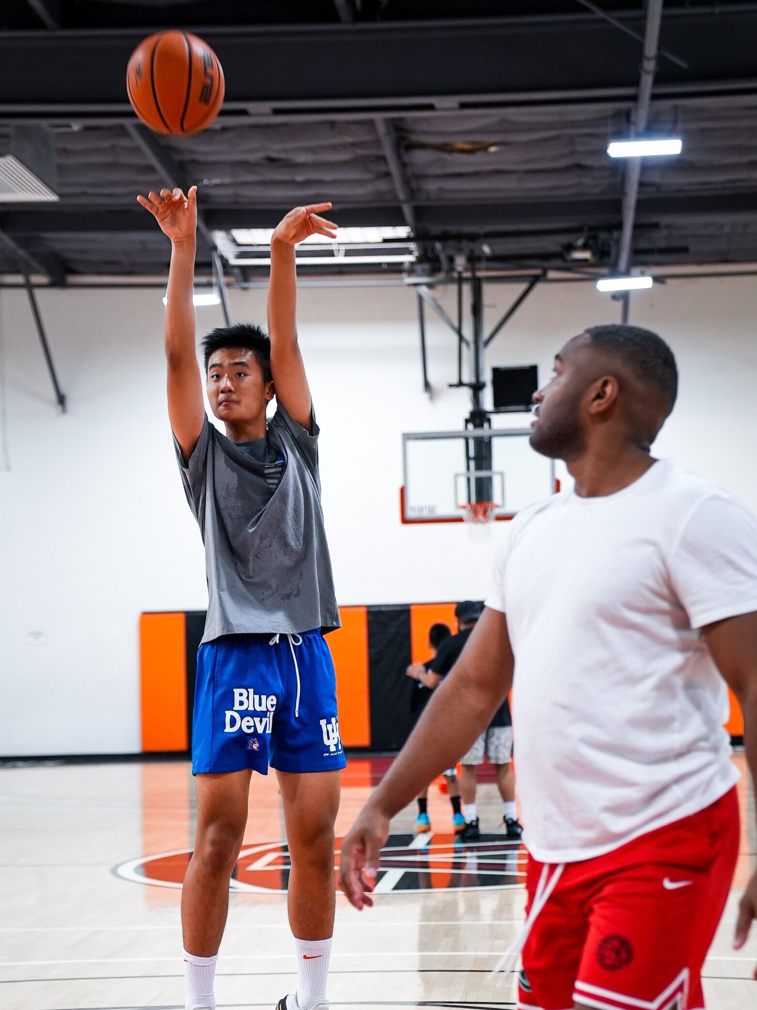 Athlete shooting over a trainer at Velocity HQ